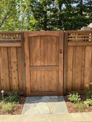 Wood gate with flagstone path and planting bed